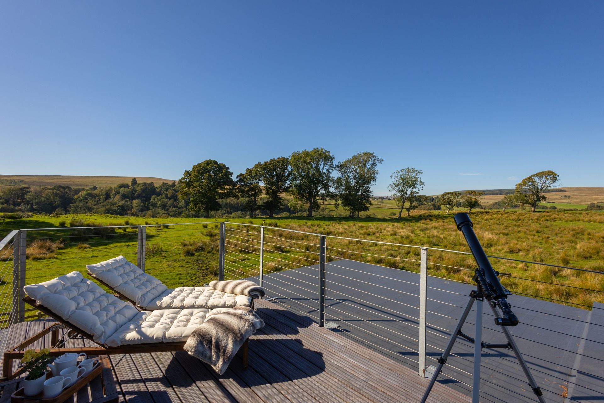 Telescope and loungers looking over the Northumberland countryside